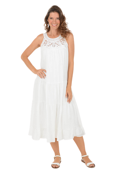 A woman wears a white crocheted halter neck midi dress.