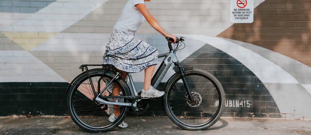 Rider getting on Gazelle Ultimate electric city bike