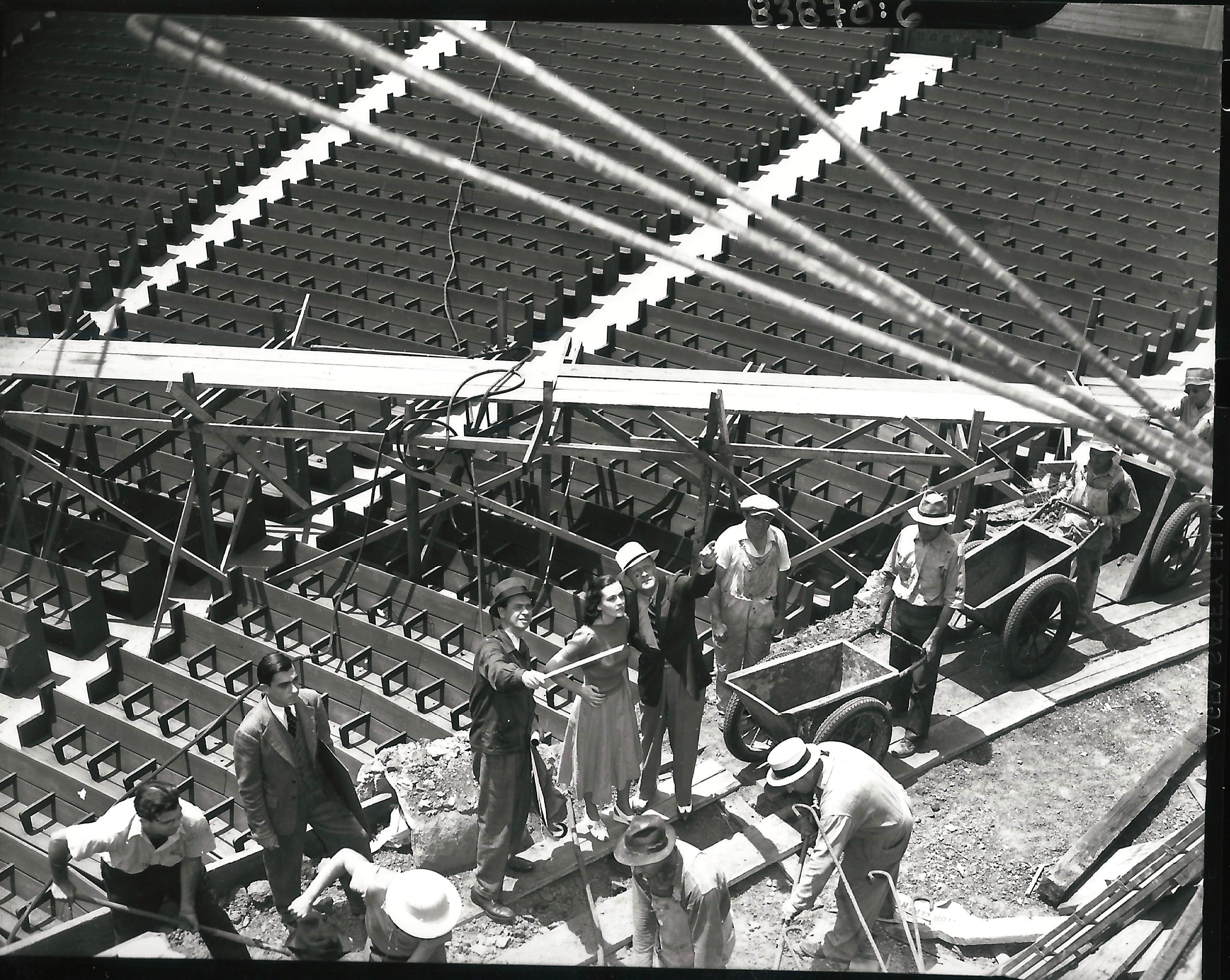 Remisoff (on the left, with pointer) oversees construction on stage right. <br> Photo courtesy of Otto Rothschild Collection, The Music Center