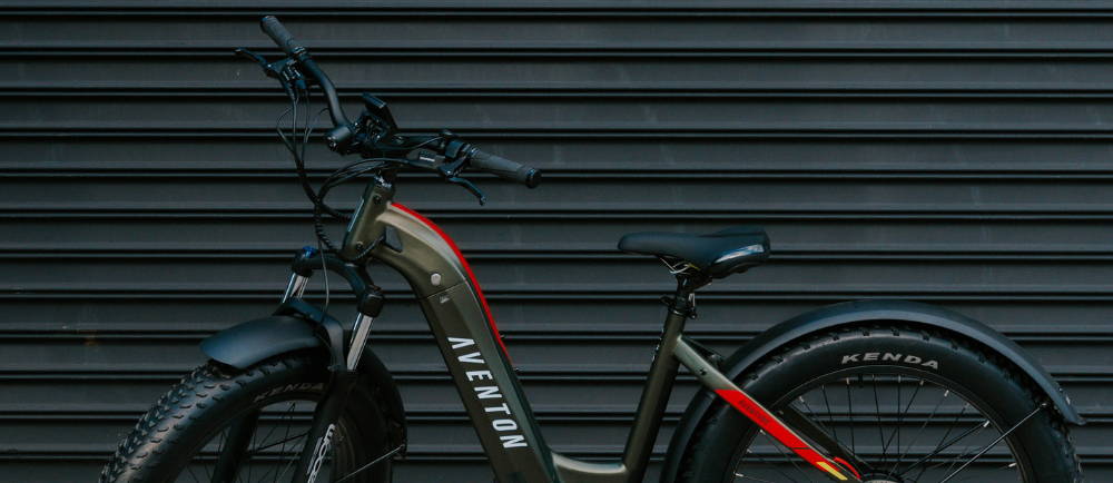 a green Aventon Aventure elctric fat tire bike against a black background