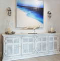 Image is of a white sideboard with a whale on a stand.
