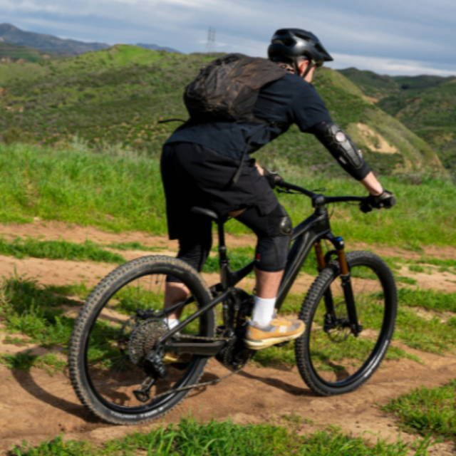 a man riding a full suspension electric mountain bike