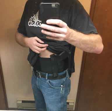 a male customer using dragon belly holster take a selfie