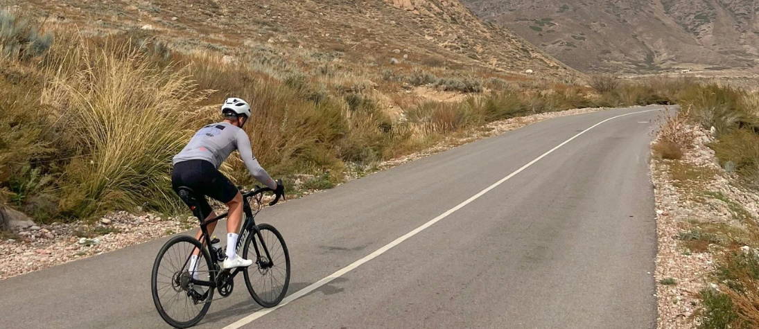 A gravel cyclist on a road. 