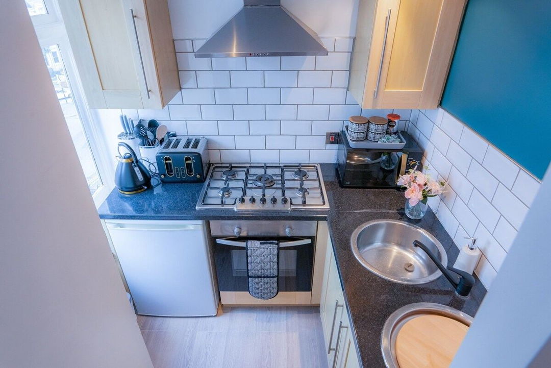 kitchen overview showing L shaped cabinets
