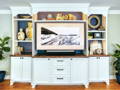 Custom wall unit with cabinets on bottom, adjustable shelving on side pieces, and space for TV in middle section. 