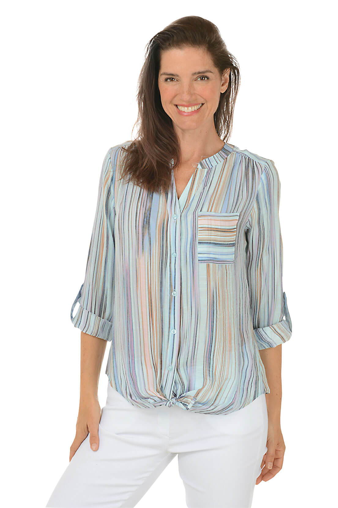 A woman wears a striped blouse and white pants against a white background