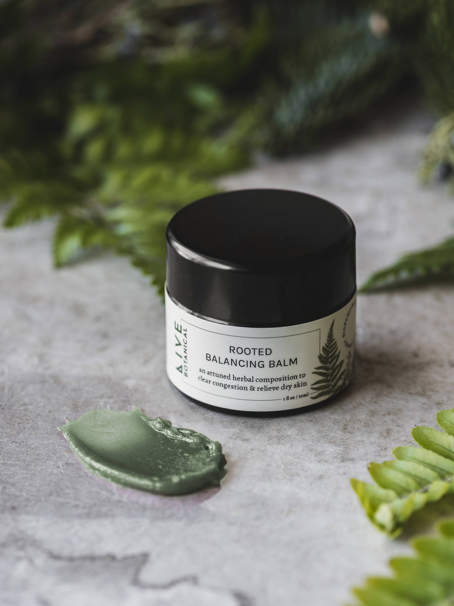Skin Repair Balm with jar lid opened revealing a golden, soft textured balm