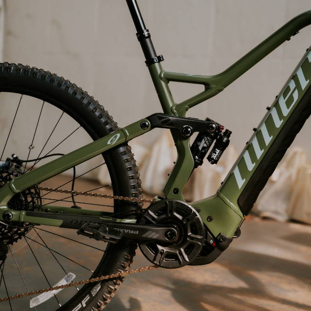 A e-MTB on a large grassy hill.