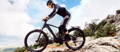 Man riding a Cube electric mountain bike on rocky route