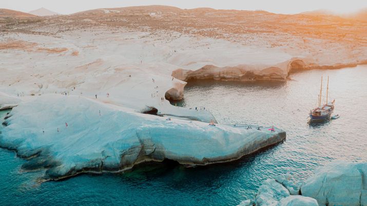 Known as the Island of Colors, Milos Island Greece is celebrated for its striking geological formations, including vibrant cliffs, multicolored rocks, and intriguing volcanic landscape