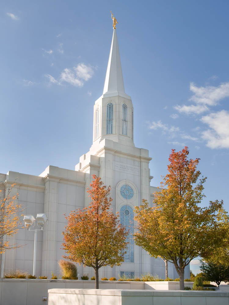 St. Louis Temple against a clear sky. It is surrounded by fall trees.