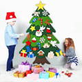 Brother and sister adding decorations to Montessori Christmas Tree. 