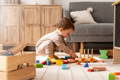 Little boy playing with wooden Montessori toys. 