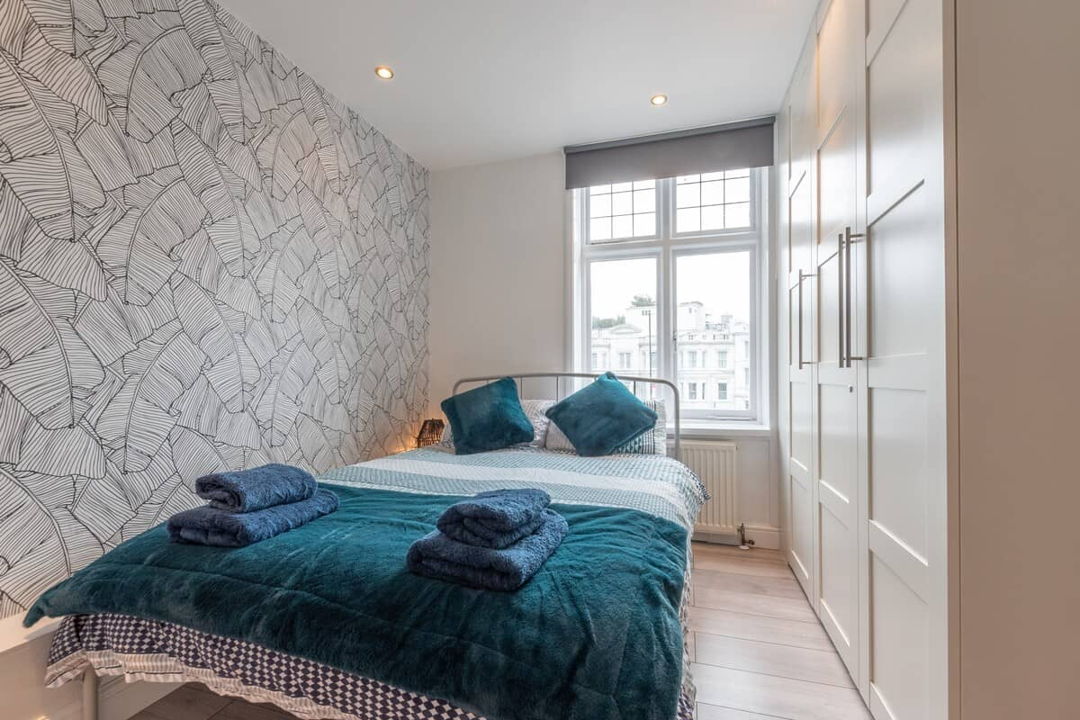 Bedroom with large double bed and large amount of clothing storage