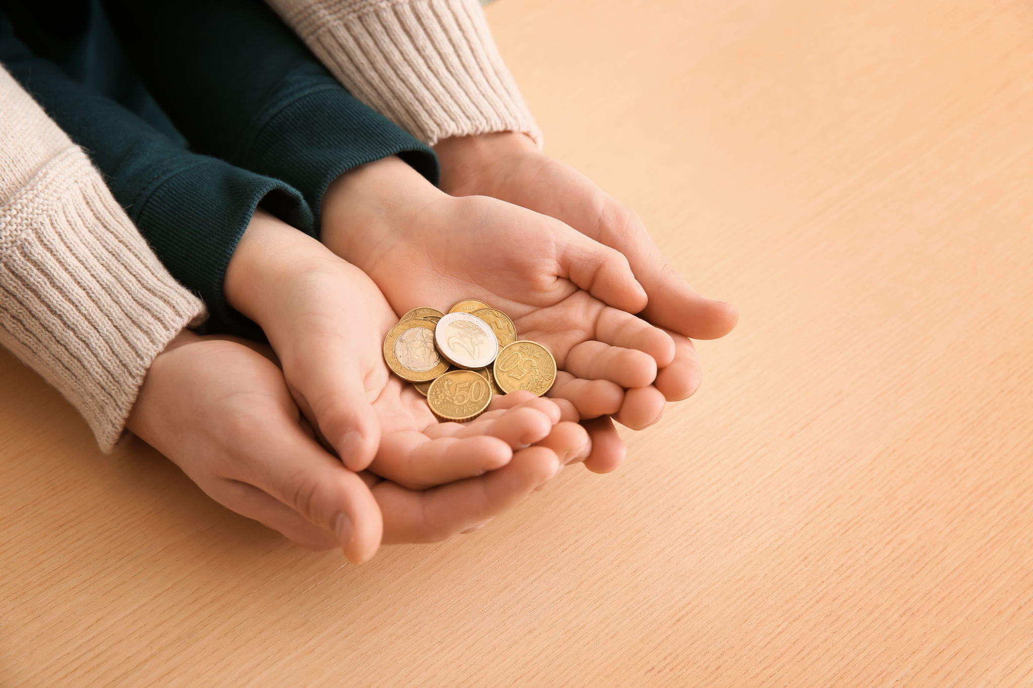 child's hand with coins