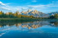 Tetons reflecting in water of Schwabacker Landing, Teton National Park.