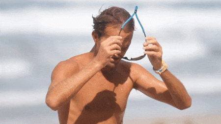 Pro surfer Anthony Osment puts on his Rheos shades before hitting the waves.