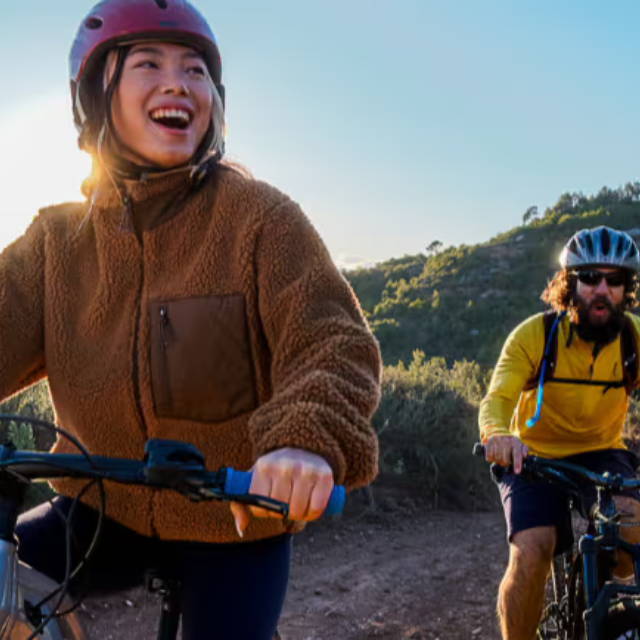 a woman and man riding bikes together