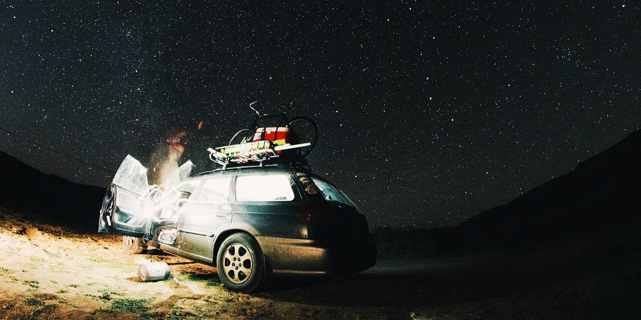 Starry night with a Subaru Outback camping vehicle