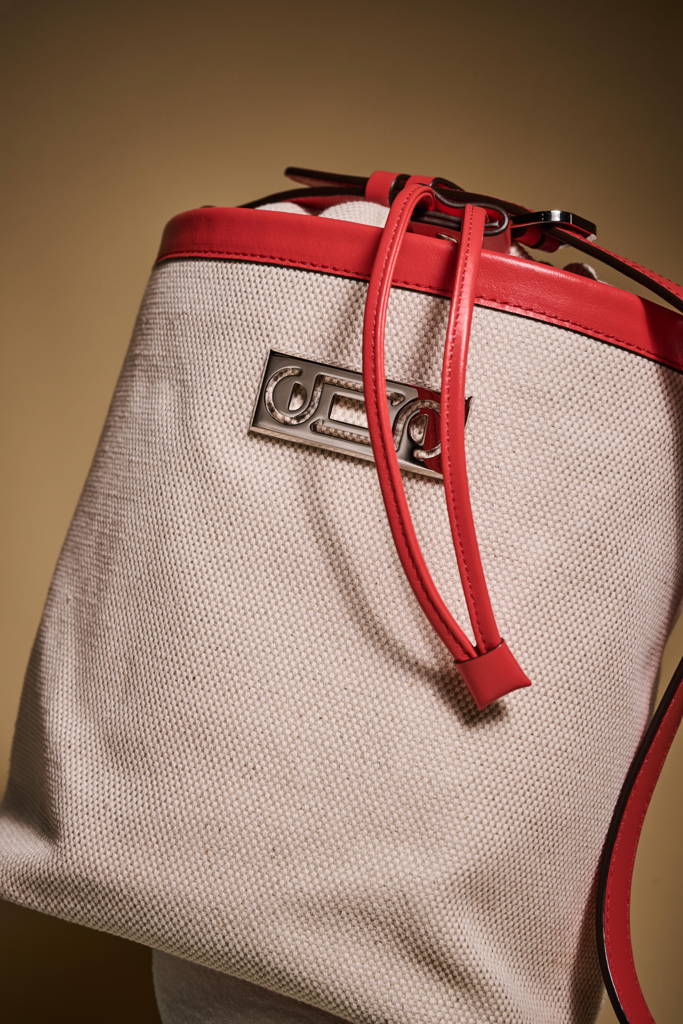 A close-up of The Francesca Canvas Bucket, showcasing the beauty of its hardware, the natural texture of its cotton-linen canvas, and the smooth leather details that define its refined craftsmanship.