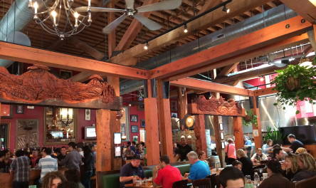inside Portland Public House, it is busy, there are wooden beams and mirrors and artwork on the wall