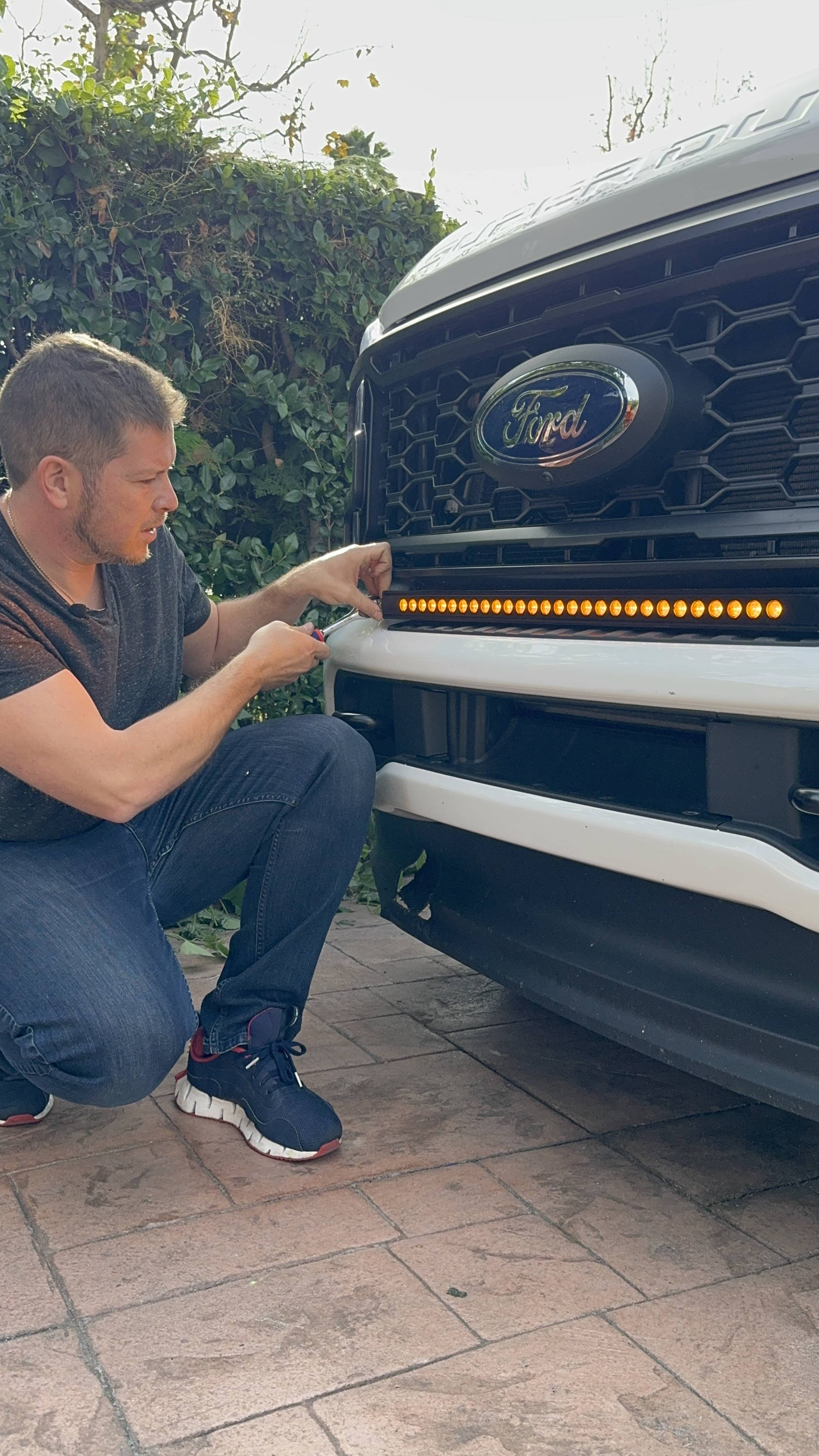 mike owner of m&R automotive has led light bar installed on white ford superduty