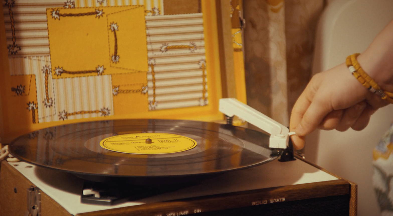 Girl putting on a vinyl record to play. 