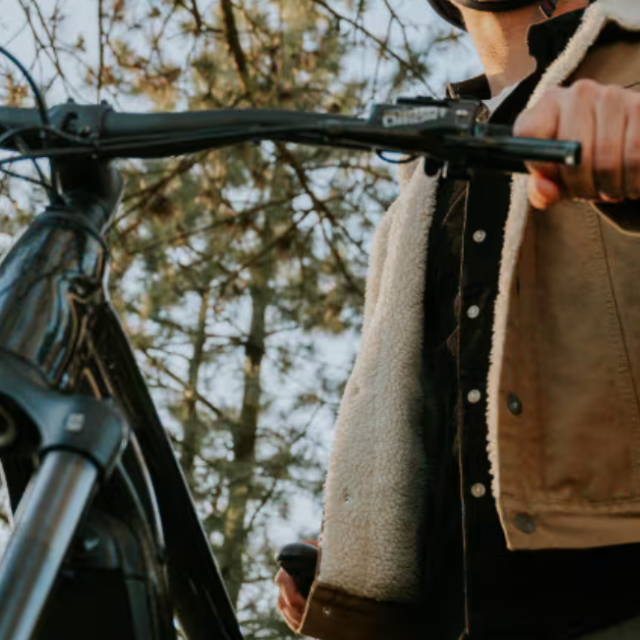 a man standing next to an electric mountain bike