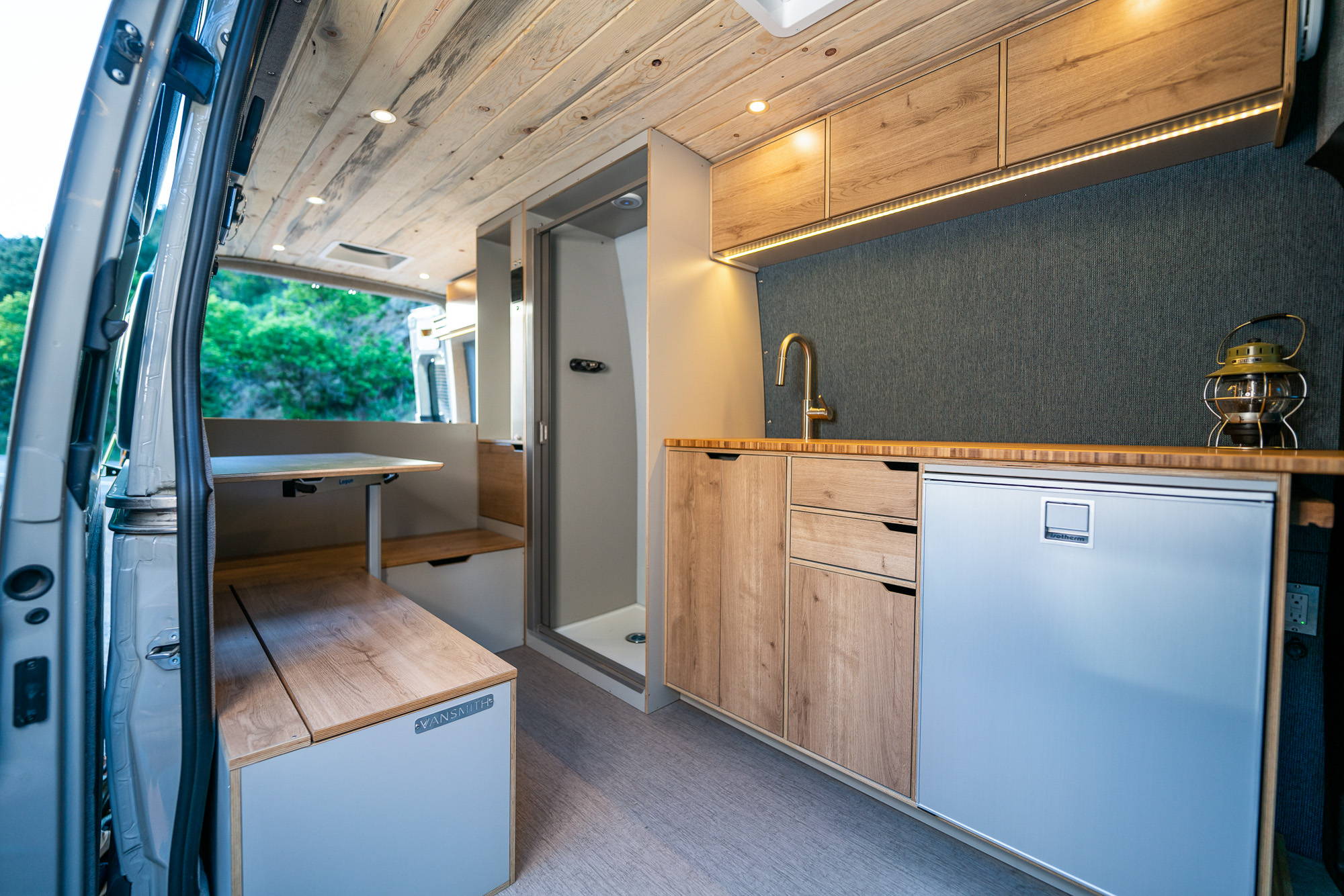 Interior of Sprinter Van Conversion in Colorado by The Vansmith with Luxury Wood Finishes
