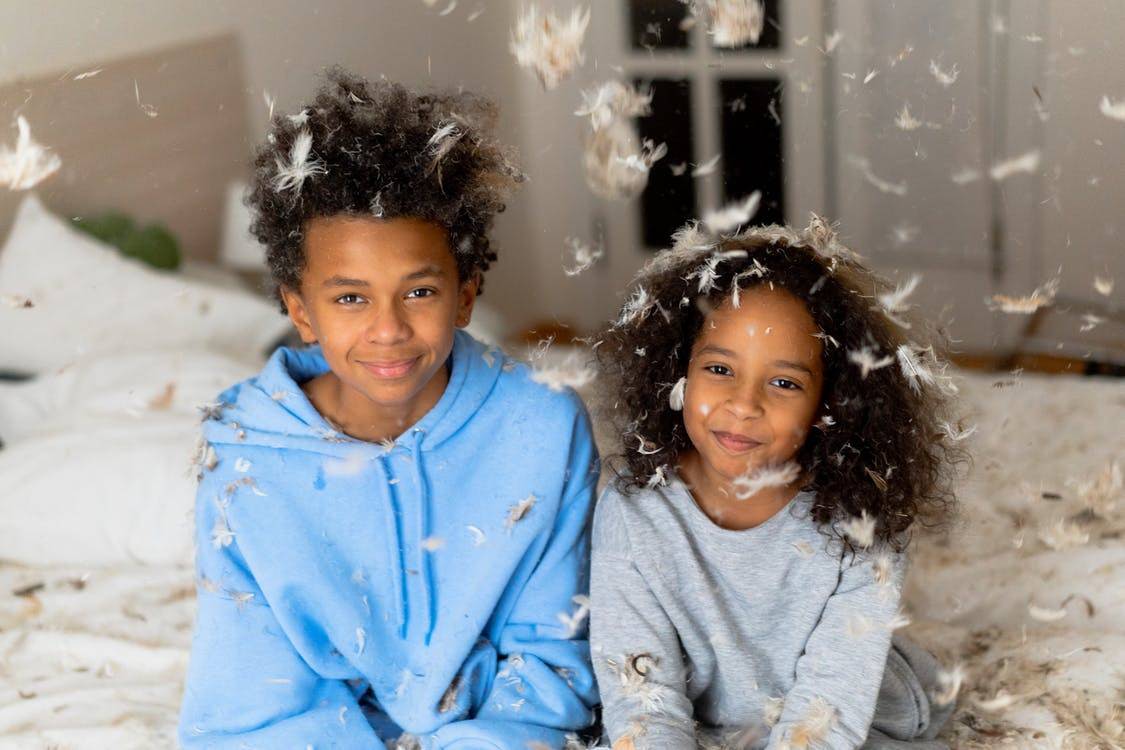Kidz drizzled with feather pillow stuffing Photo by cottonbro from Pexels