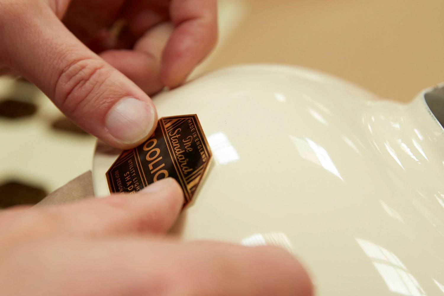 The Coolicon gold badge is applied by hand onto a Cream lampshade