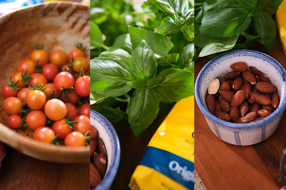 Cherry tomatoes on wooden bowl, freshly cut sweet basil and a handful of almonds