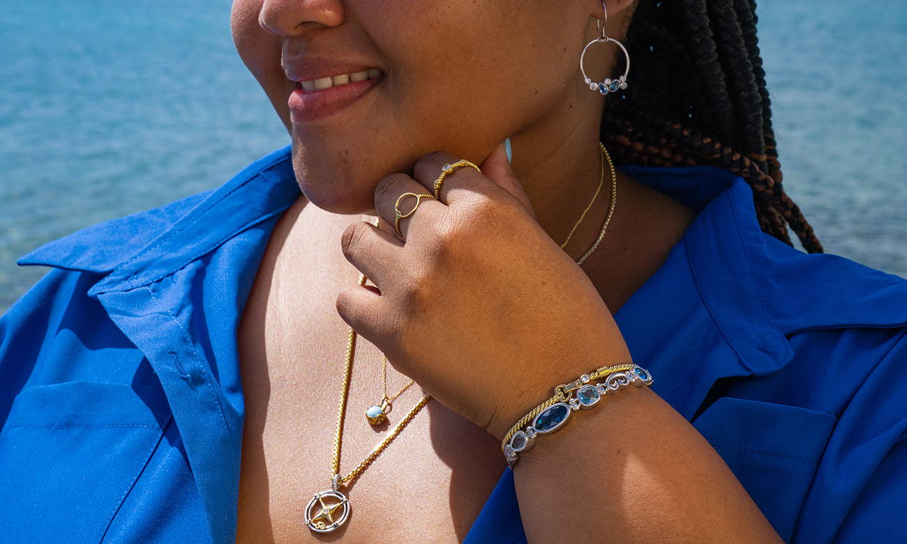Women smiling wearing Vibe Jewelry bracelets, pendants, rings and earrings.