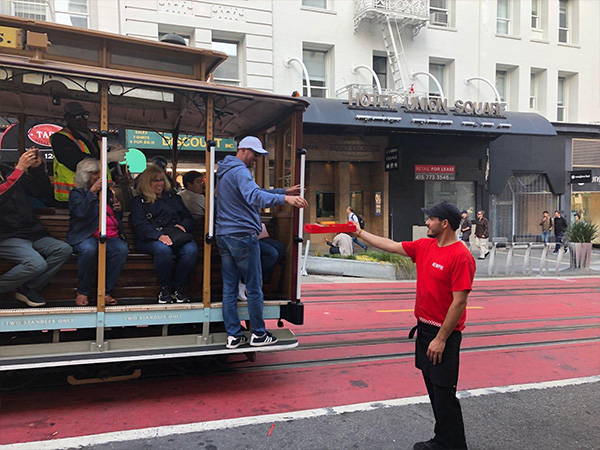 Giving samples to trolley riders as they go by