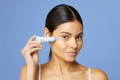 woman applying eye cream to the under eye area