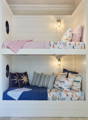built-in bunk beds with nautical ship lights and porthole