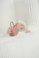 Albinism female model lying on a white softwall with a NOIRANCA handbag Amanda in Dusty Rose