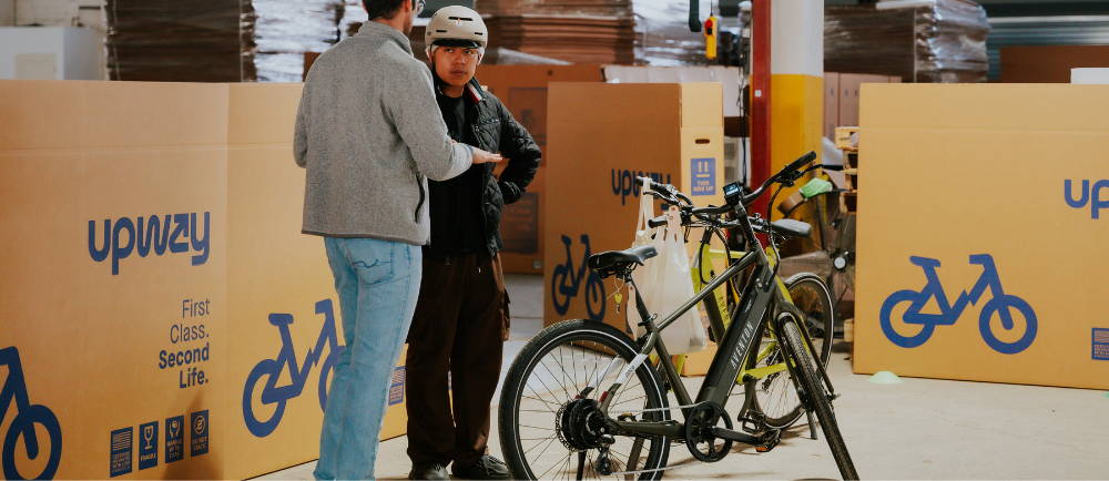 2 people talking about e-Bikes in an Upway location