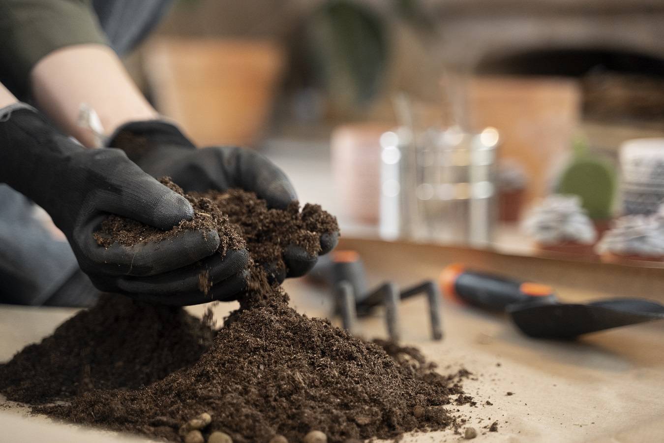 side-view-hands-holding-potting-soil