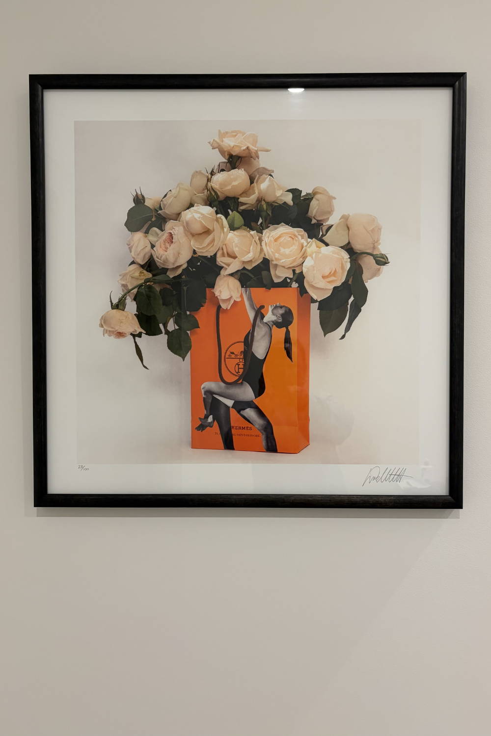 'Bagged It/Hermes Swing' by Dina Broadhurst - An art print framed in black with pink garden roses placed in an iconic orange Hermes shopping bag.