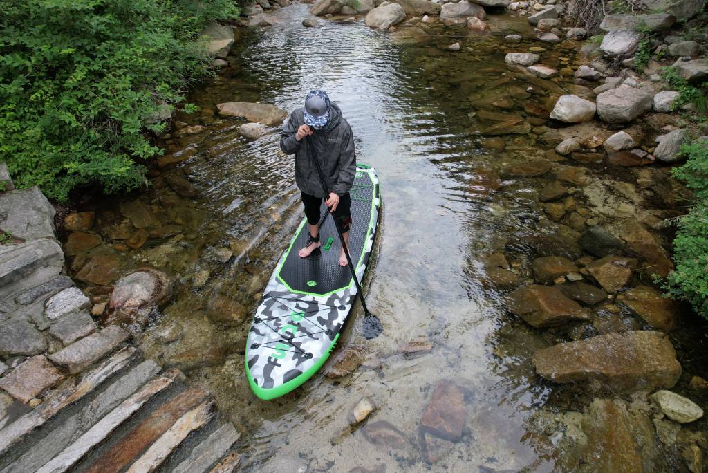 Inflatable paddle board in summer with hat