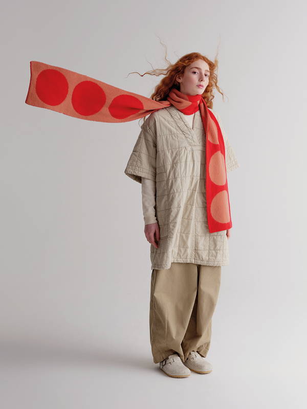 model wears brushed spot scarf poppy and plaster