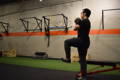 Jason Li is exercising with a kettlebell