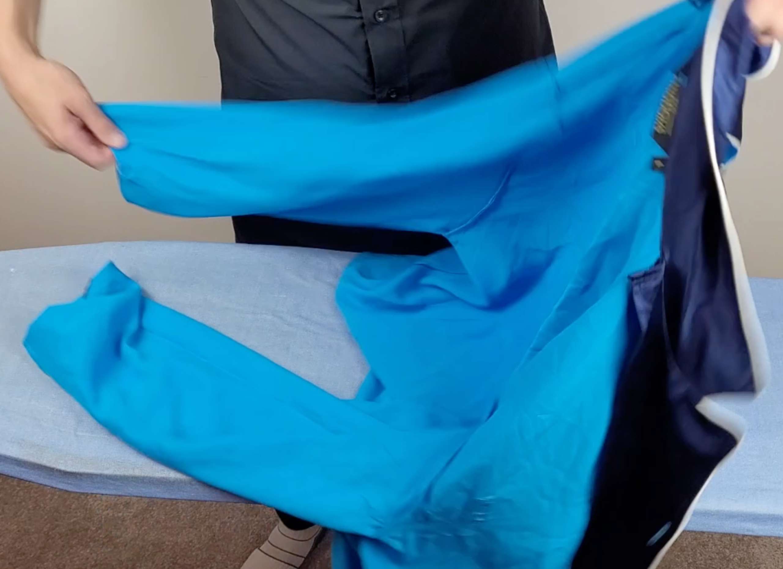 photo of a man turning blue satin pajamas inside out