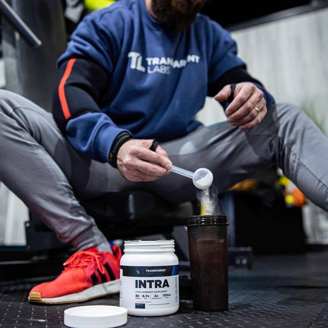 athlete pouring transparent labs intra workout in a shaker athlete pouring transparent labs intra workout in a shaker