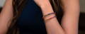 Woman with stacked sapphire rainbow bracelets on her wrist