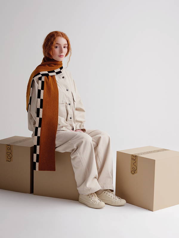 model wears Chequered Edge Scarf Cumin