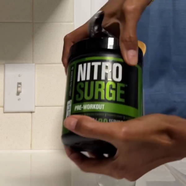 athlete shows his bottle of mr nitrosurge pre workout