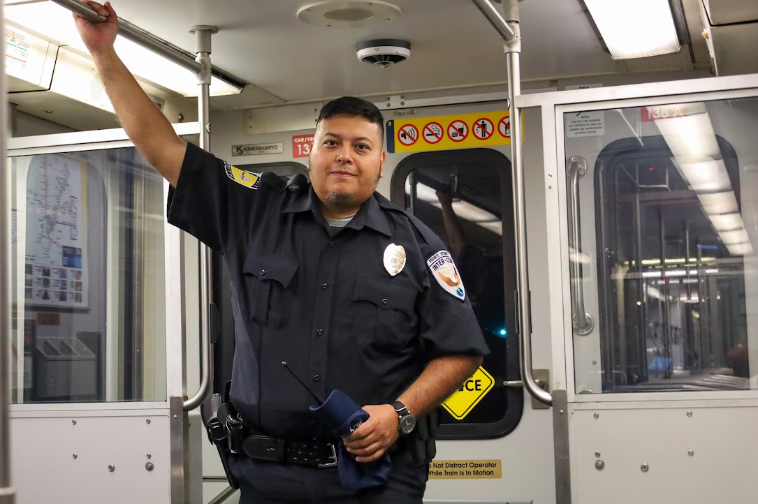 Transit Security Officer standing aboard a DART light rail train.